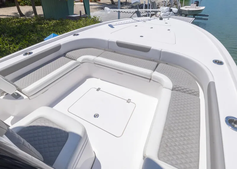 Slide: The Image of 2023 Caymas 28 HB boat with spacious seating and storage, docked by the water. - 10