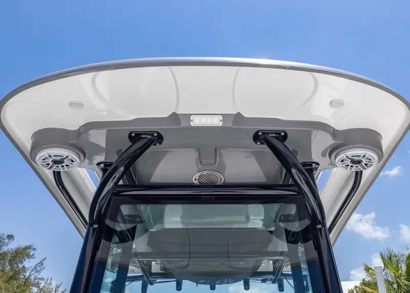 Slide: The Image of 2023 Caymas 28 HB boat canopy with speakers against a clear blue sky. - 15