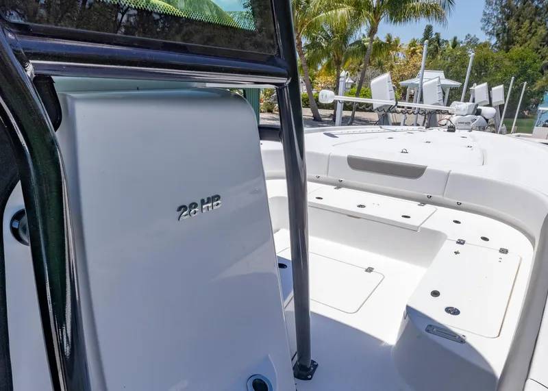 Slide: The Image of 2023 Caymas 28 HB boat interior with sleek white design and spacious deck. - 23