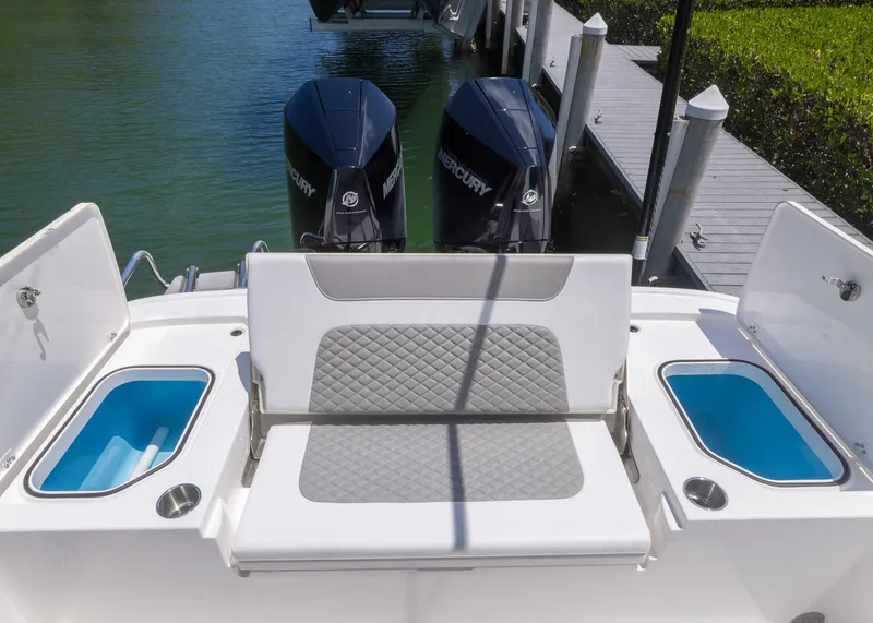 Slide: The Image of 2023 Caymas 28 HB boat with dual Mercury engines and cushioned seating. - 26