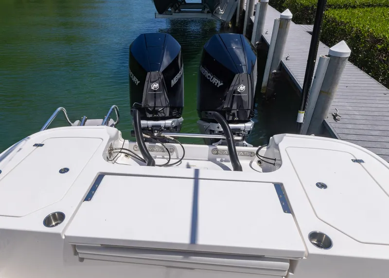 Slide: The Image of 2023 Caymas 28 HB boat with dual Mercury outboard engines at dock. - 27