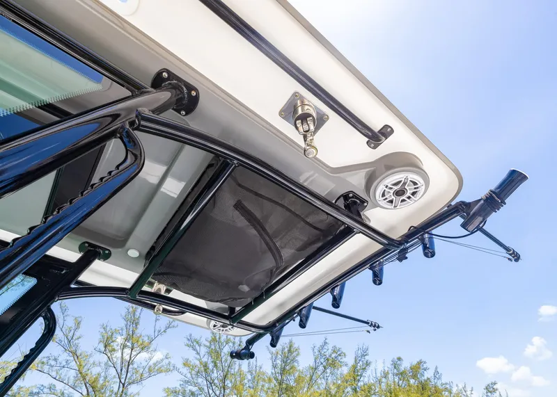 Slide: The Image of 2023 Caymas 28 HB boat canopy with speaker and rod holders under a clear blue sky. - 30