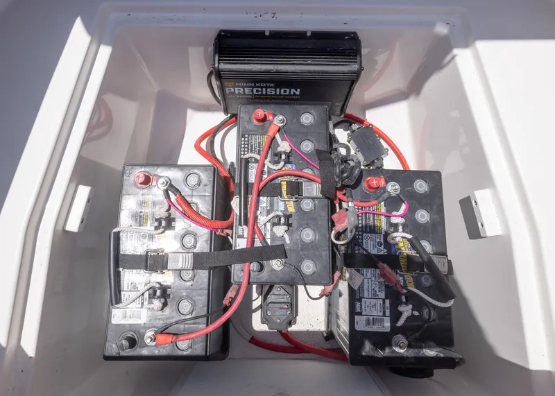 Slide: The Image of 2023 Caymas 28 HB boat battery compartment with multiple batteries and wiring. - 31