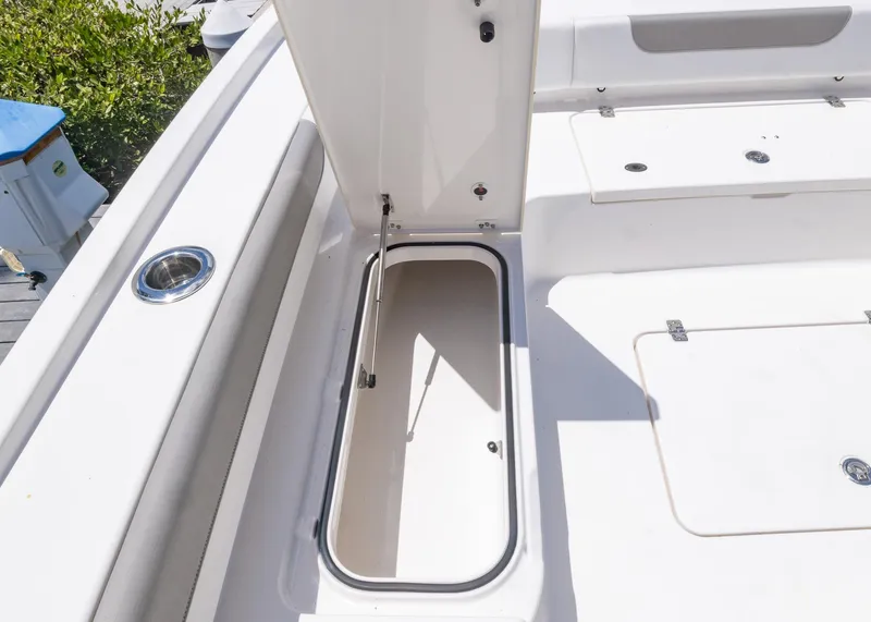 Slide: The Image of 2023 Caymas 28 HB boat storage compartment with open hatch, showcasing spacious interior. - 33