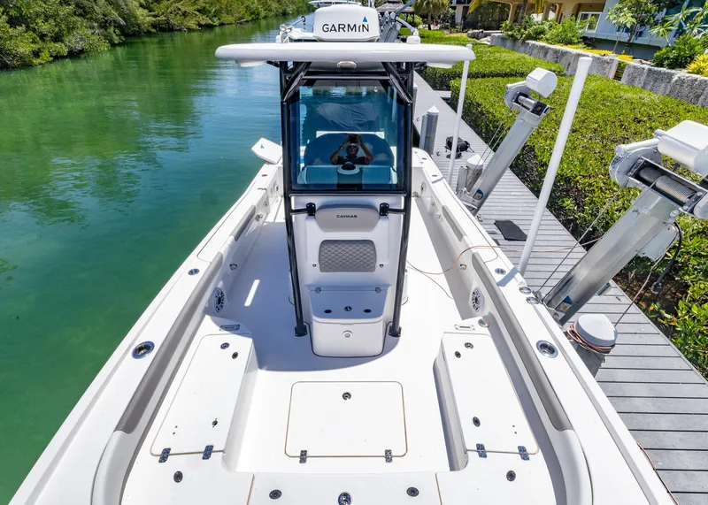 Slide: The Image of 2023 Caymas 28 HB boat docked on a serene waterway, featuring advanced Garmin navigation. - 6