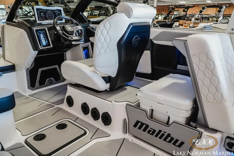 Slide: The Image of 2021 Malibu M240 boat interior with modern dashboard and luxurious seating at Lake Norman Marina. - 10