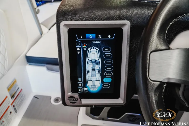 Slide: The Image of 2021 Malibu M240 boat dashboard with touchscreen control panel at Lake Norman Marina. - 14