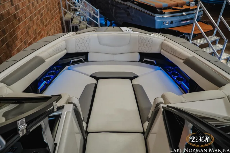 Slide: The Image of 2021 Malibu M240 boat interior with luxurious seating and ambient lighting at Lake Norman Marina. - 15