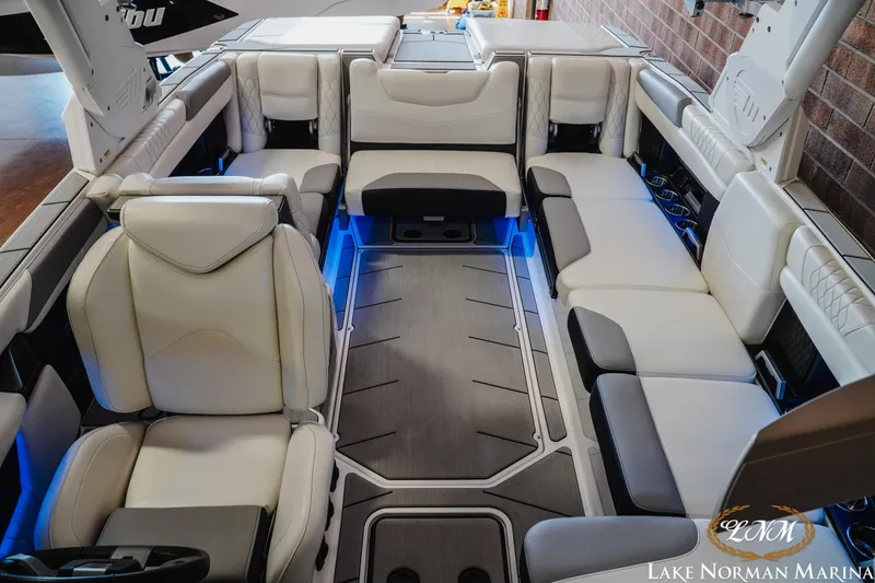 Slide: The Image of Luxurious interior of 2021 Malibu M240 boat with plush seating and ambient lighting. - 17