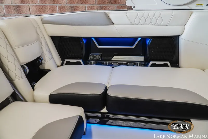 Slide: The Image of Luxurious interior of 2021 Malibu M240 boat with plush seating and ambient lighting. - 20