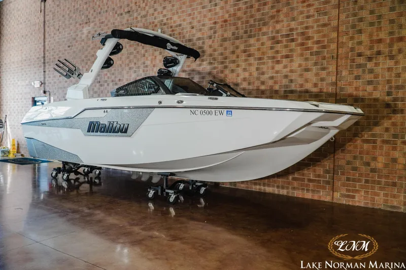 Slide: The Image of 2021 Malibu M240 boat displayed indoors at Lake Norman Marina. - 3