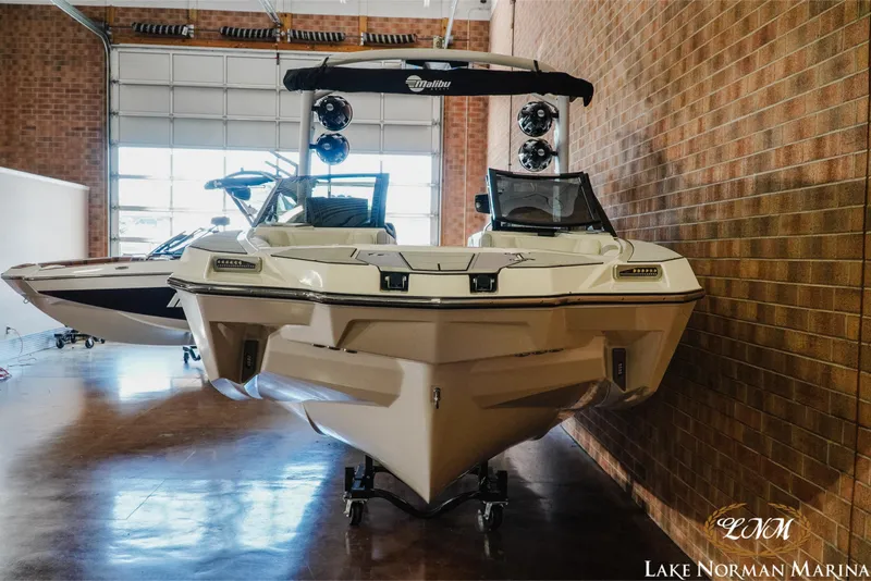 Slide: The Image of 2021 Malibu M240 boat displayed indoors at Lake Norman Marina. - 4