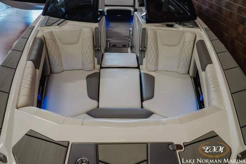 Slide: The Image of 2021 Malibu M240 boat interior with luxurious seating and ambient lighting at Lake Norman Marina. - 5