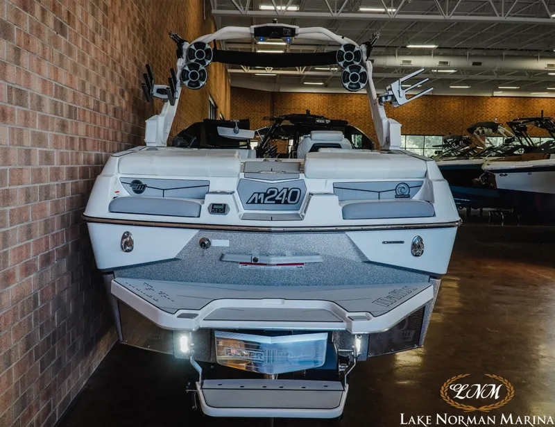 Slide: The Image of 2021 Malibu M240 boat displayed indoors at Lake Norman Marina. - 7