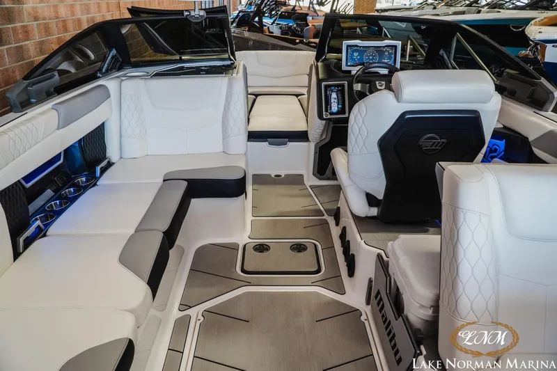 Slide: The Image of Luxurious interior of a 2021 Malibu M240 boat with modern seating and dashboard. - 9