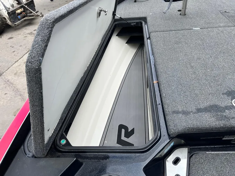 Slide: The Image of 2023 Ranger Z521R boat storage compartment with open lid, showcasing interior design. - 12