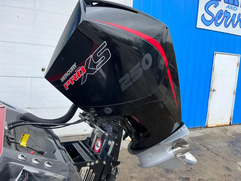Slide: The Image of 2023 Ranger Z521R with Mercury Pro XS 250 outboard motor, parked near a blue building. - 14