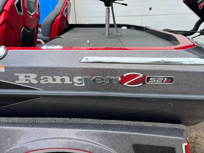 Slide: The Image of 2023 Ranger Z521R boat with red and gray detailing, featuring comfortable seating. - 15