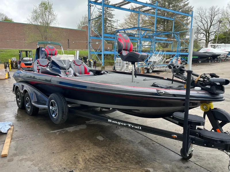 Slide: The Image of 2023 Ranger Z521R boat on trailer, parked outdoors, featuring sleek design and modern seating. - 5