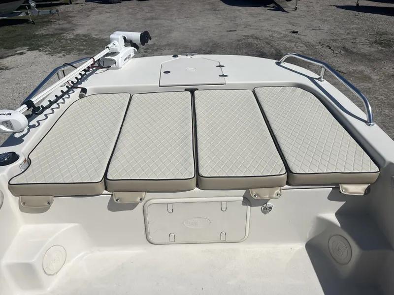 Slide: The Image of 2021 Carolina Skiff 25 LS boat with cushioned seating and storage compartments. - 12