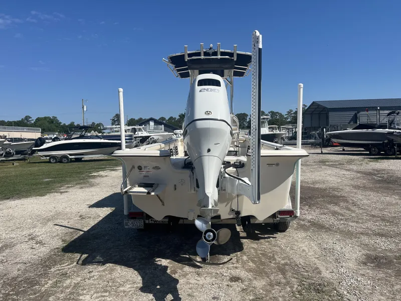 Slide: The Image of 2021 Carolina Skiff 25 LS boat, rear view, parked outdoors on gravel. - 3