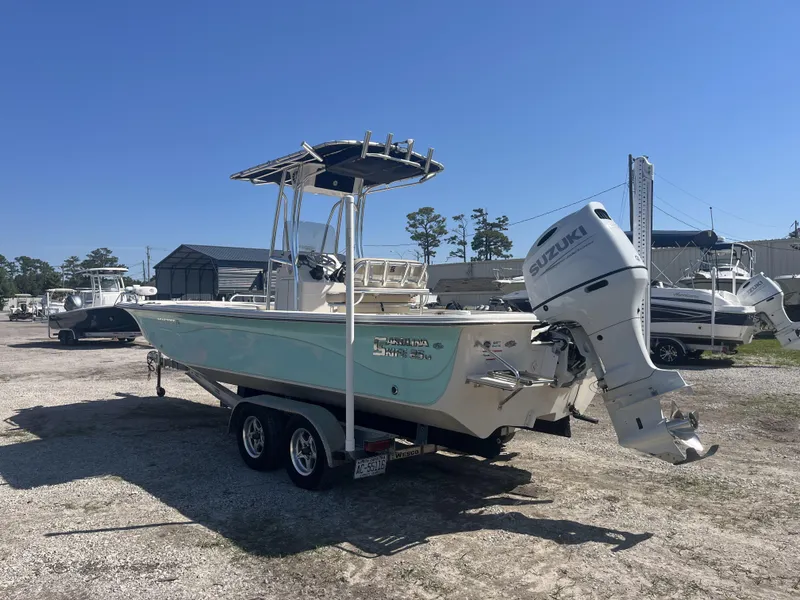 Slide: The Image of 2021 Carolina Skiff 25 LS boat with Suzuki outboard motor on a trailer. - 4