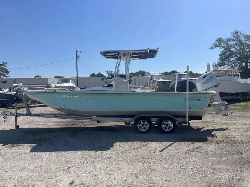 Slide: The Image of 2021 Carolina Skiff 25 LS boat on trailer, parked outdoors under clear sky. - 5