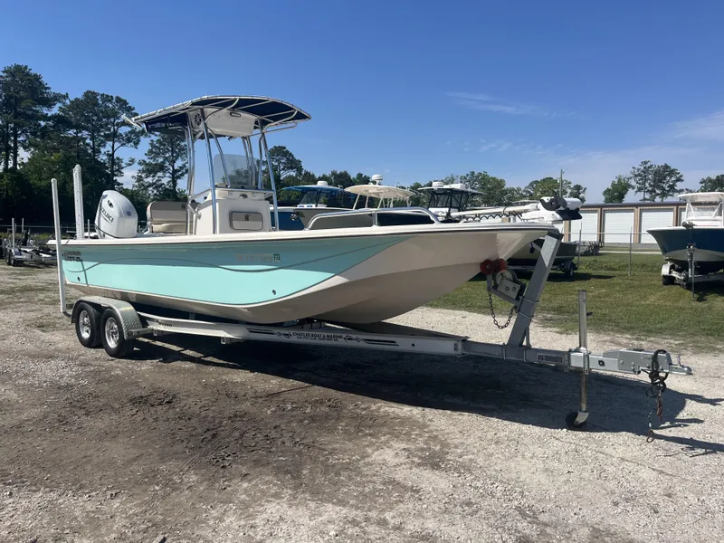 Slide: The Image of 2021 Carolina Skiff 25 LS boat on trailer, parked outdoors under clear sky. - 8