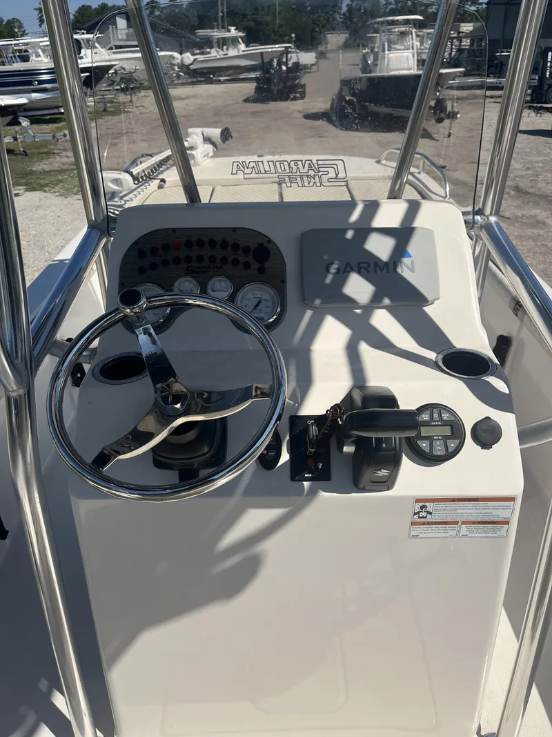 Slide: The Image of 2021 Carolina Skiff 25 LS boat console with steering wheel and Garmin navigation system. - 9