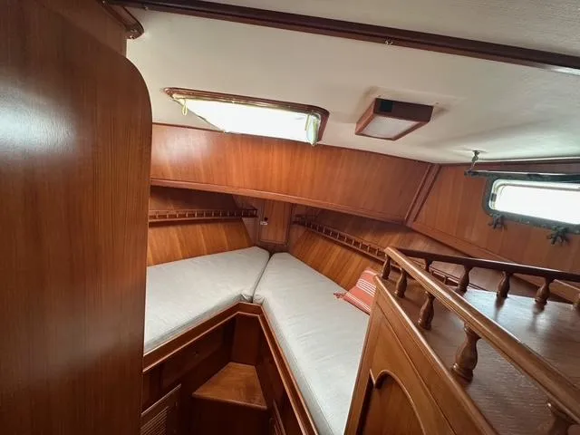 Slide: The Image of 1987 Albin Double Cabin interior with wooden finish and cozy sleeping area. - 21