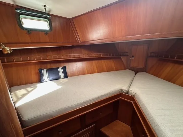 Slide: The Image of 1987 Albin Double Cabin interior with wooden finish and cozy sleeping area. - 22