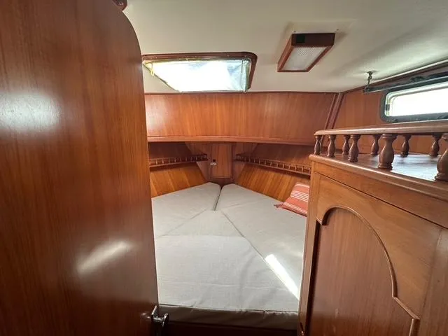 Slide: The Image of 1987 Albin Double Cabin interior with wooden finish and cozy sleeping area. - 23