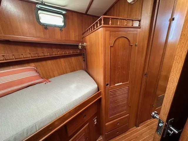 Slide: The Image of 1987 Albin Double Cabin interior with wooden finish and cozy bed. - 24