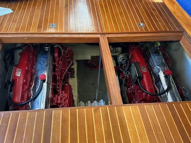 Slide: The Image of Engine compartment of a 1987 Albin Double Cabin boat with twin red engines. - 30