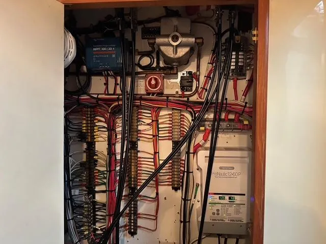 Slide: The Image of Electrical panel inside a 1987 Albin Double Cabin boat, featuring organized wiring and components. - 33