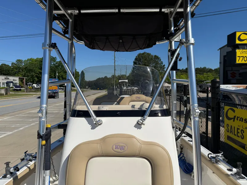 Slide: The Image of 2020 Key West 210 BR boat with T-top, parked near a sales lot. - 18