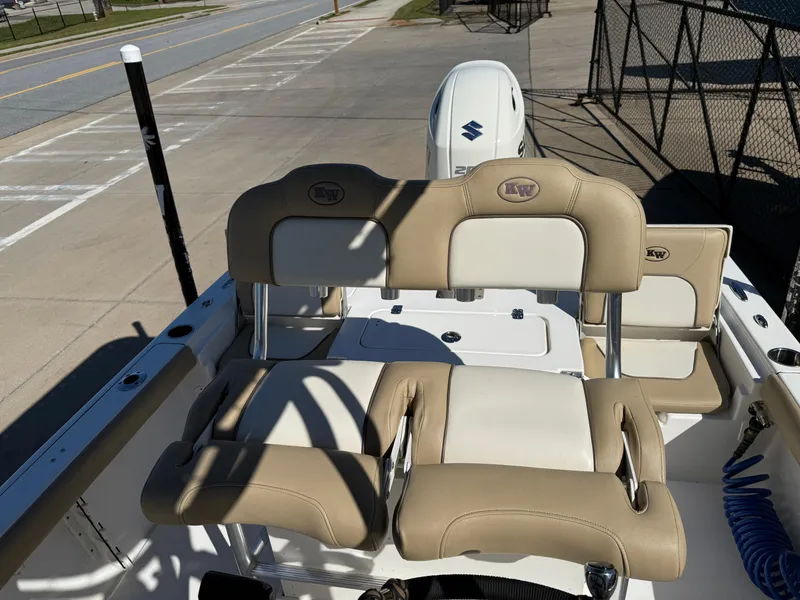 Slide: The Image of 2020 Key West 210 BR boat interior with beige seating and Suzuki outboard motor. - 21