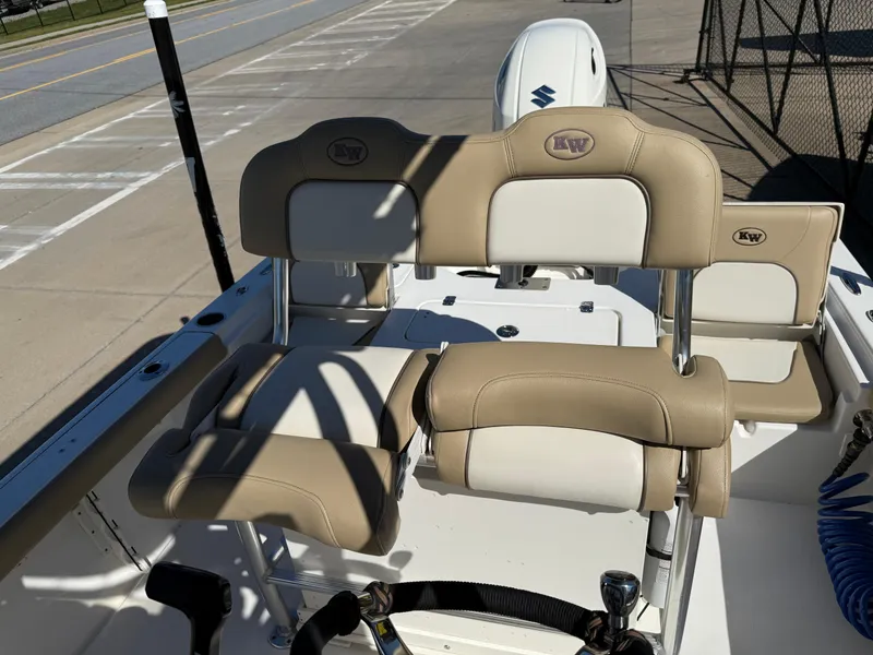 Slide: The Image of 2020 Key West 210 BR boat interior with beige seating and Suzuki outboard motor. - 22