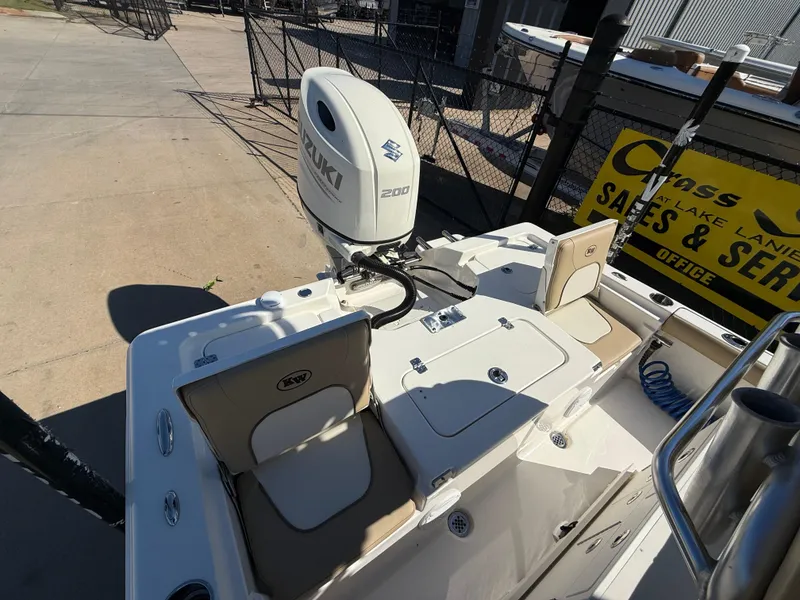 Slide: The Image of 2020 Key West 210 BR boat with Suzuki 200 engine, docked near sales and service area. - 23