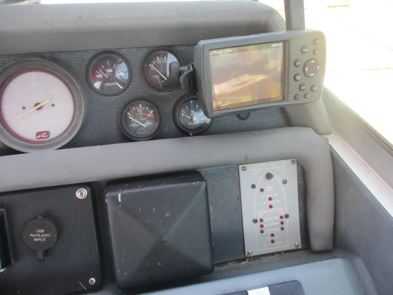 Slide: The Image of Control panel of a 1991 Sea Ray 350 Express Cruiser with gauges and navigation system. - 10