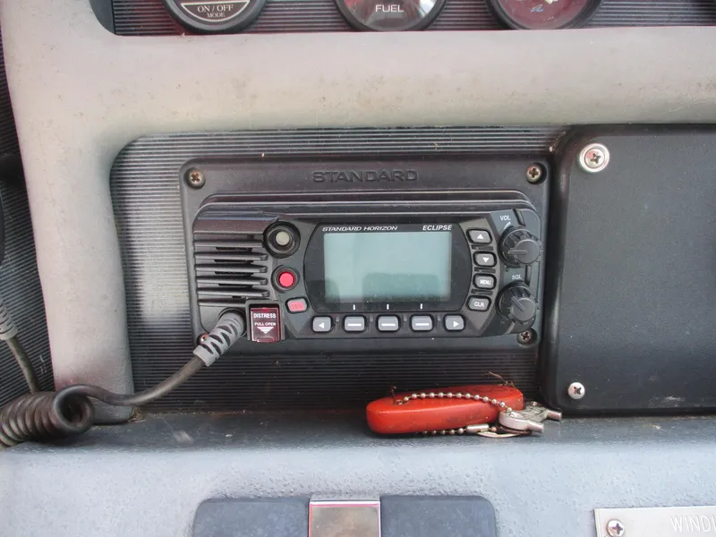 Slide: The Image of Marine radio on 1991 Sea Ray 350 Express Cruiser dashboard with keys. - 11