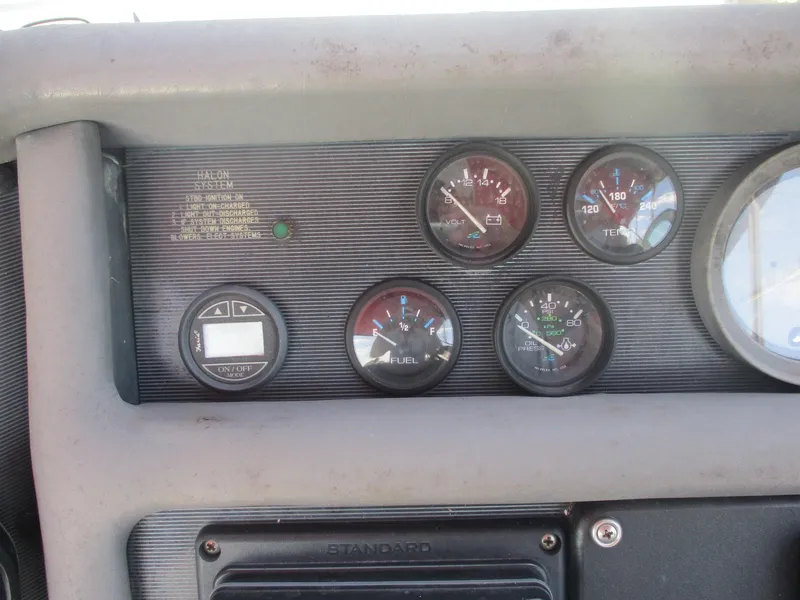 Slide: The Image of Dashboard gauges of a 1991 Sea Ray 350 Express Cruiser boat. - 13