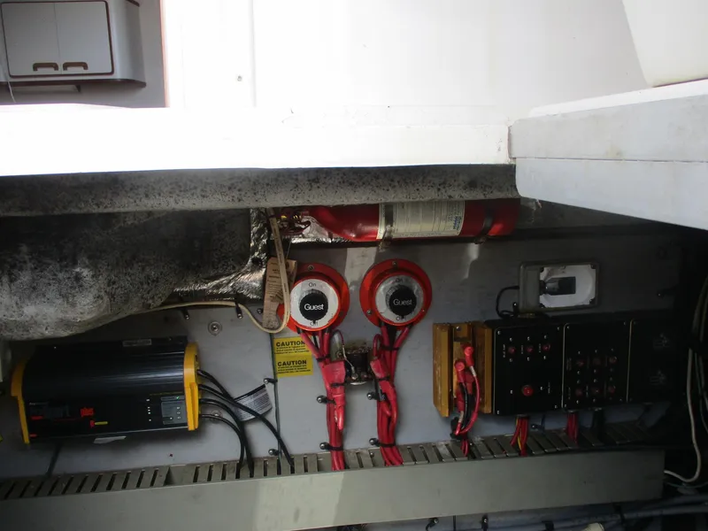 Slide: The Image of Engine compartment of a 1991 Sea Ray 350 Express Cruiser with wiring and fire extinguisher. - 35