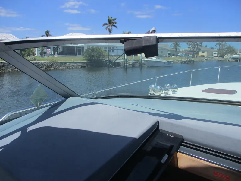 Slide: The Image of 1991 Sea Ray 350 Express Cruiser interior view with waterfront background. - 38
