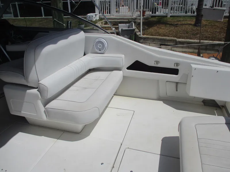 Slide: The Image of 1991 Sea Ray 350 Express Cruiser interior with white seating and clean design. - 5