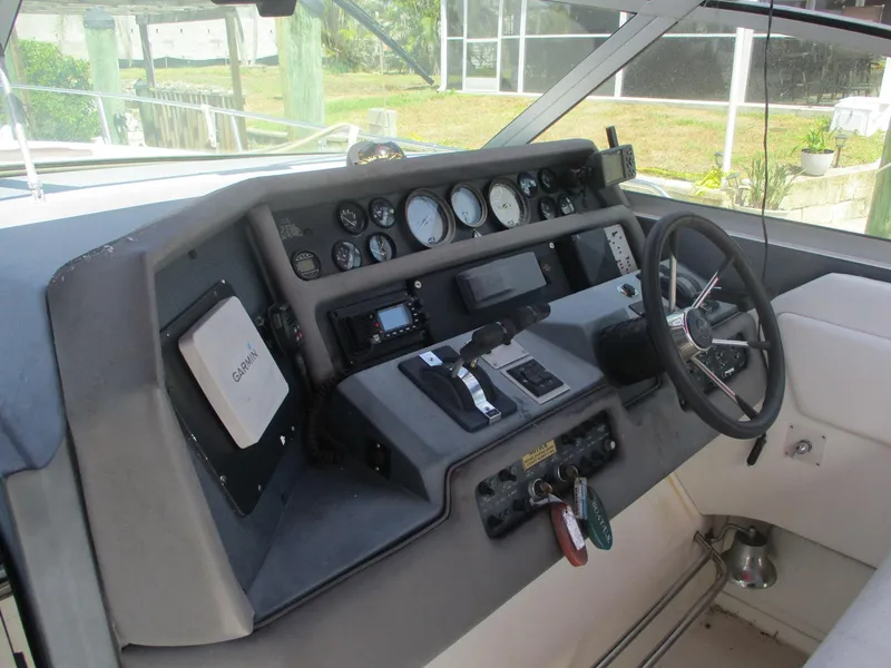 Slide: The Image of 1991 Sea Ray 350 Express Cruiser dashboard with steering wheel and control panel. - 7