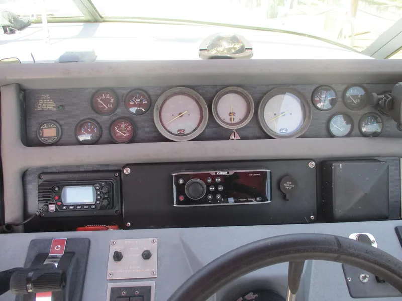 Slide: The Image of 1991 Sea Ray 350 Express Cruiser dashboard with gauges and controls. - 9