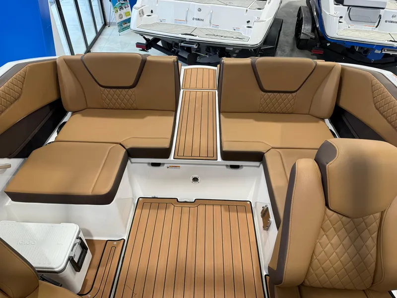 Slide: The Image of 2025 Yamaha Boats 222SD interior with tan seating and wood-style flooring. - 5
