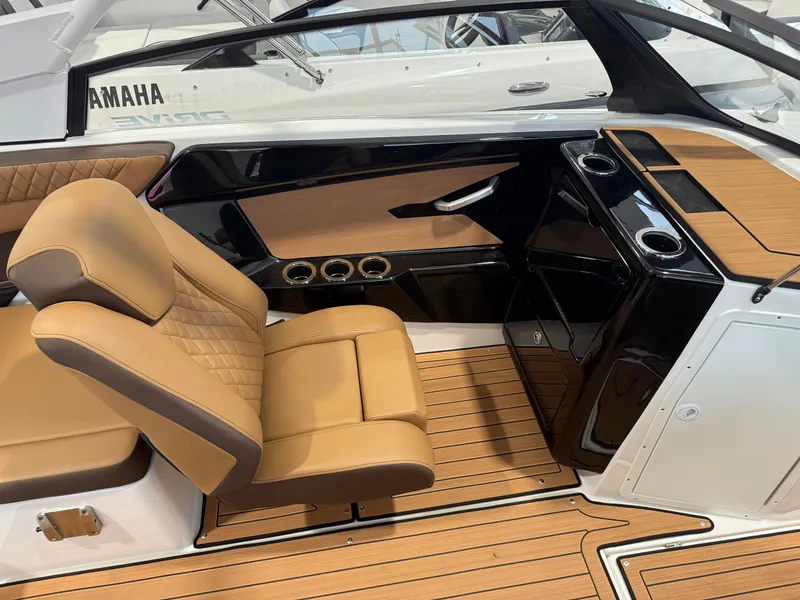 Slide: The Image of 2025 Yamaha Boats 222SD interior with tan seating and sleek black console design. - 6
