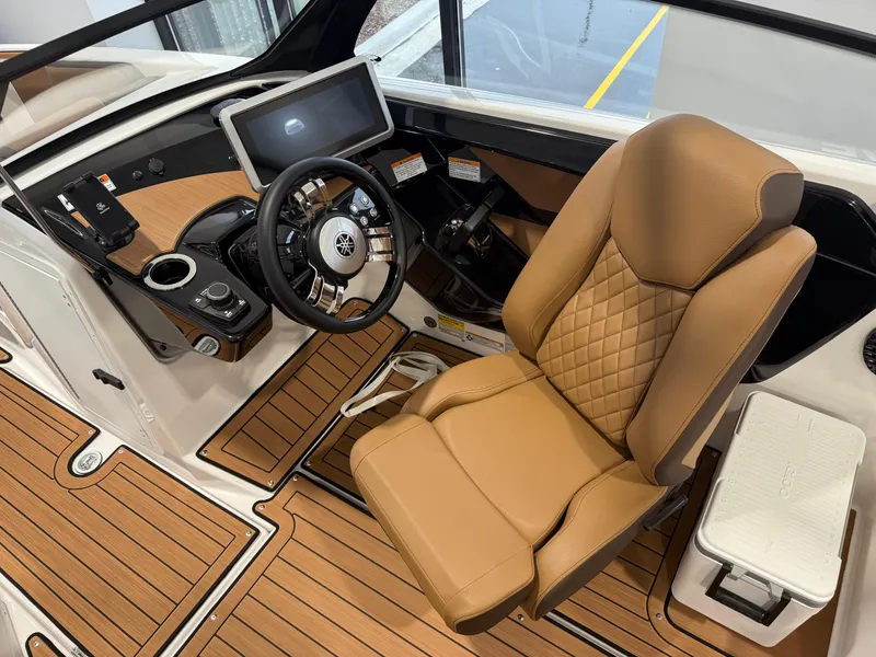 Slide: The Image of 2025 Yamaha Boats 222SD cockpit with tan leather seat and modern dashboard. - 7